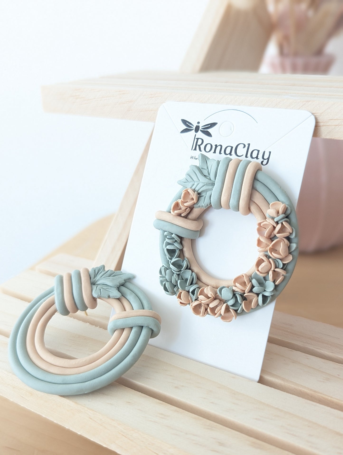 Handmade floral wreath polymer clay earrings with sage green and peach floral details
