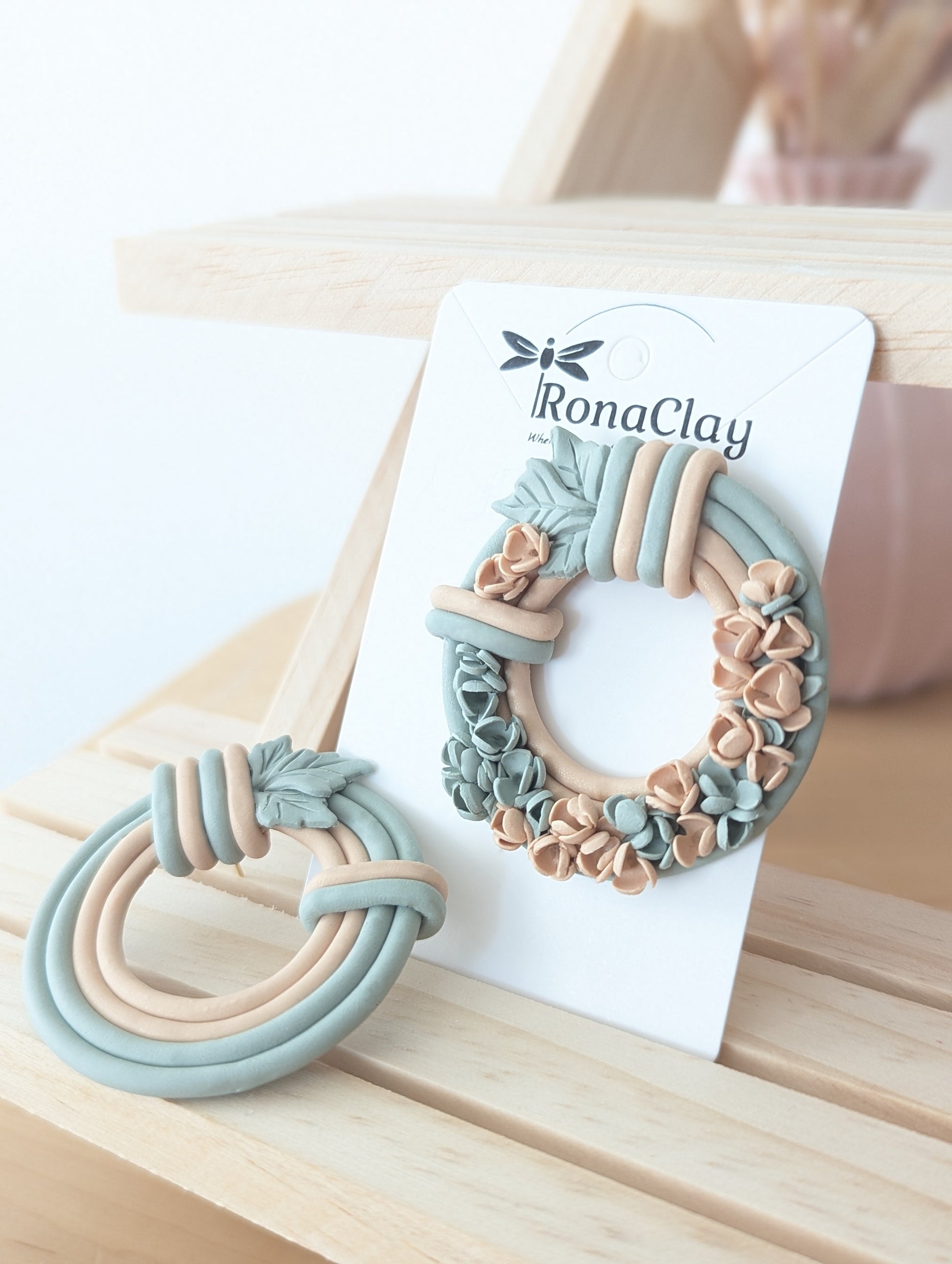 Handmade floral wreath polymer clay earrings with sage green and peach floral details